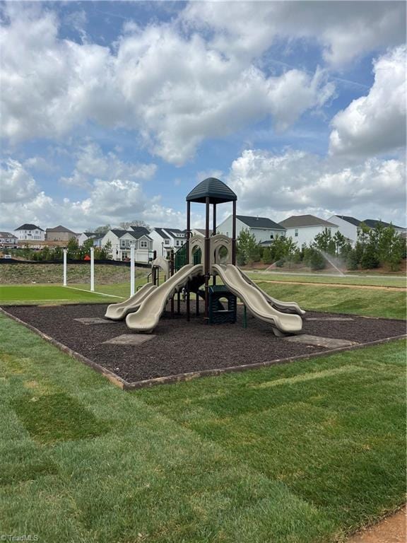 community jungle gym with a lawn and a residential view
