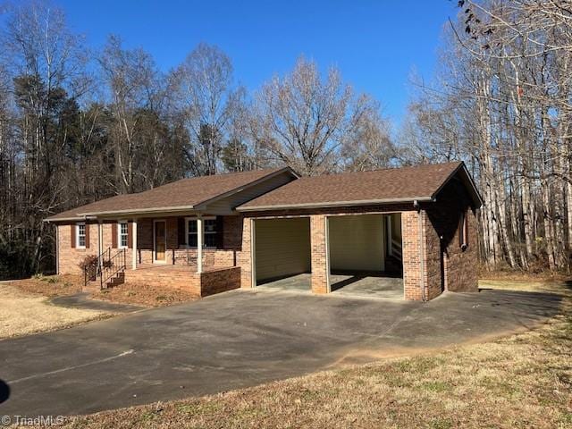 ranch-style home with a porch and a carport