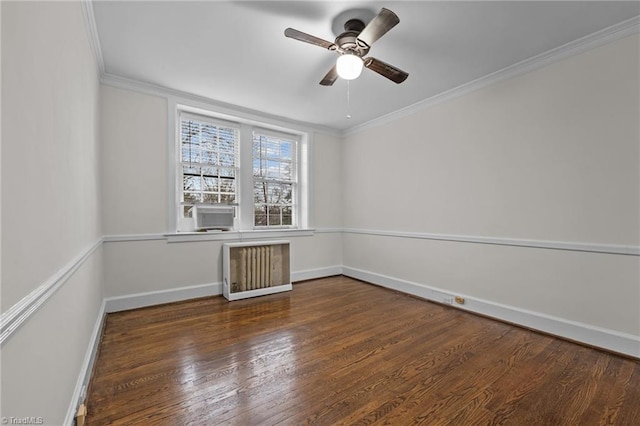 spare room featuring crown molding, baseboards, dark wood-style floors, and radiator