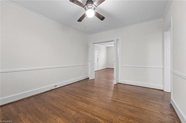 spare room featuring ceiling fan, baseboards, dark wood-style flooring, and crown molding