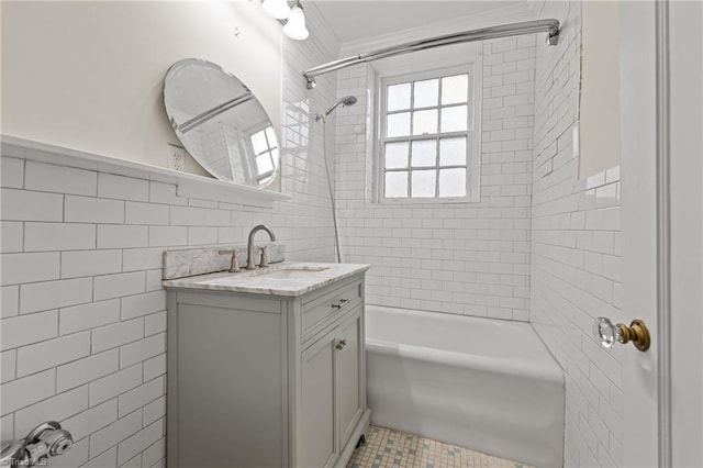 full bath featuring  shower combination, tile walls, and vanity