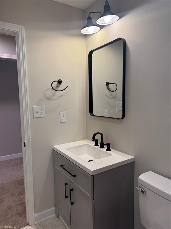 bathroom featuring vanity and toilet