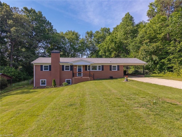 ranch-style house featuring brick siding, dirt driveway, a front lawn, and a chimney