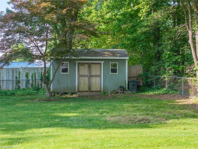 view of shed featuring fence