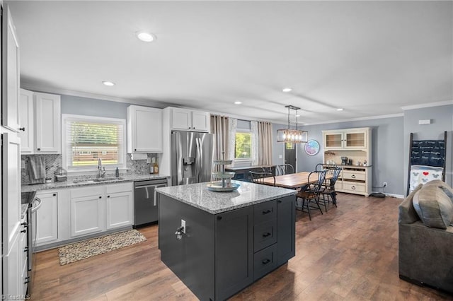 kitchen with a sink, stainless steel appliances, and white cabinetry