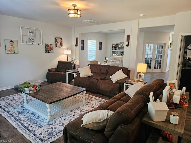 living room featuring dark hardwood / wood-style floors and french doors