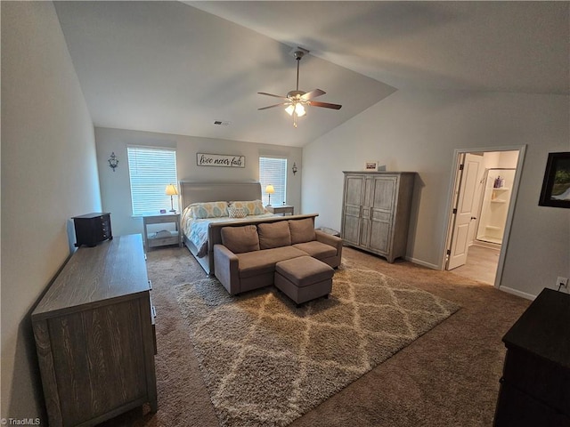 carpeted bedroom with connected bathroom, vaulted ceiling, and ceiling fan