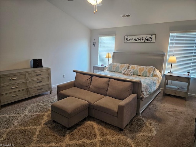 bedroom with lofted ceiling, ceiling fan, and dark carpet