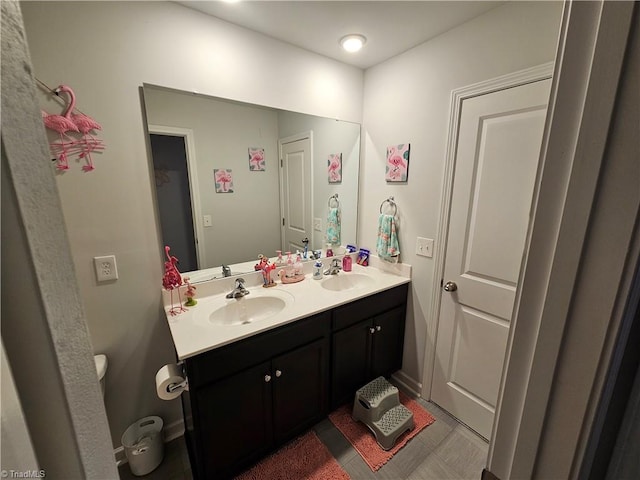 bathroom featuring vanity and toilet