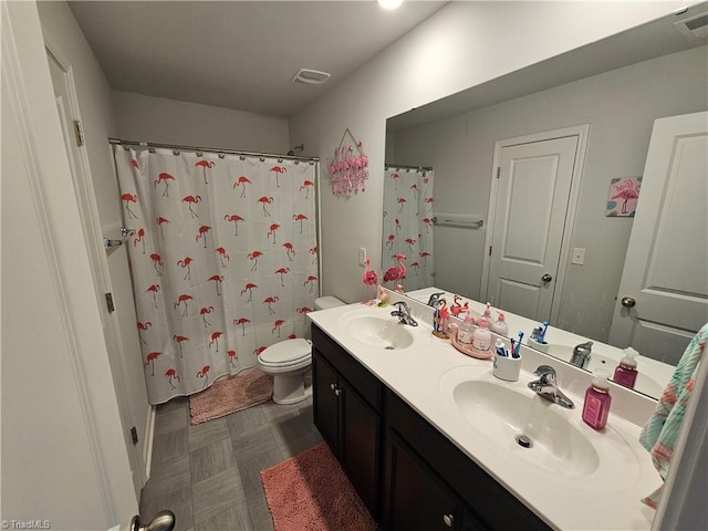 bathroom featuring walk in shower, vanity, and toilet