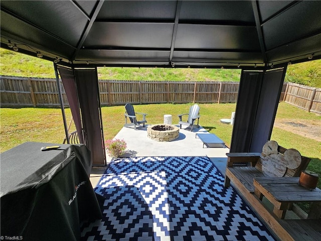 view of patio featuring a gazebo, area for grilling, and a fire pit