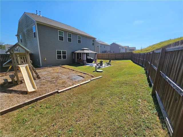 back of house with a patio area, a playground, a gazebo, and a yard