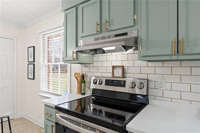 kitchen featuring under cabinet range hood, stainless steel electric stove, green cabinets, crown molding, and light countertops