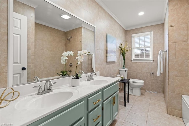 bathroom featuring a sink, tile walls, crown molding, and tile patterned floors