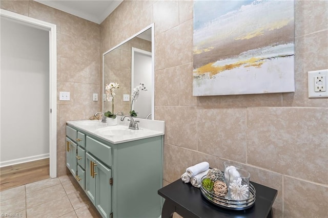 bathroom with tile patterned flooring, tile walls, double vanity, and a sink