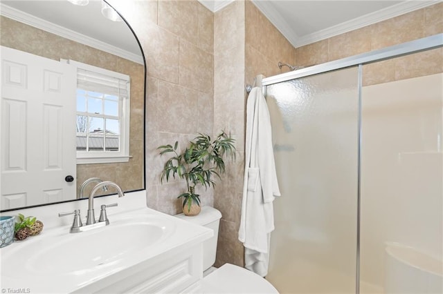 bathroom featuring toilet, tile walls, a shower stall, crown molding, and vanity