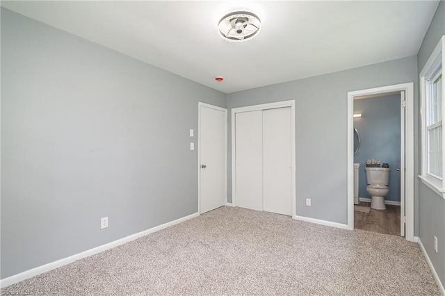 2102 Castlerock Rd, Greensboro, NC 27406 - unfurnished bedroom with carpet, a closet, baseboards, and connected bathroom