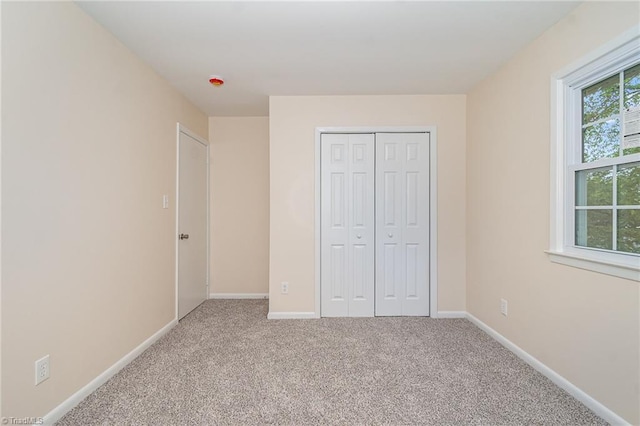 2102 Castlerock Rd, Greensboro, NC 27406 - unfurnished bedroom featuring carpet flooring, a closet, and baseboards