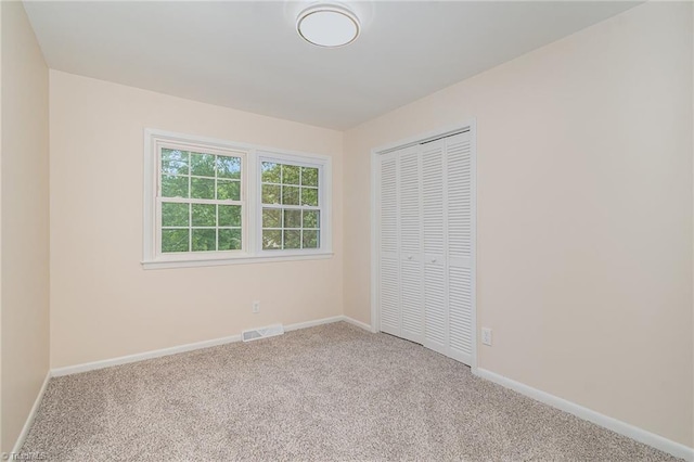 2102 Castlerock Rd, Greensboro, NC 27406 - unfurnished bedroom with carpet flooring, a closet, and baseboards