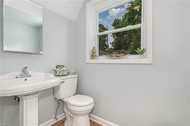 2102 Castlerock Rd, Greensboro, NC 27406 - bathroom featuring toilet, baseboards, and lofted ceiling