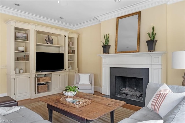 living room with a fireplace with flush hearth, wood finished floors, baseboards, and ornamental molding