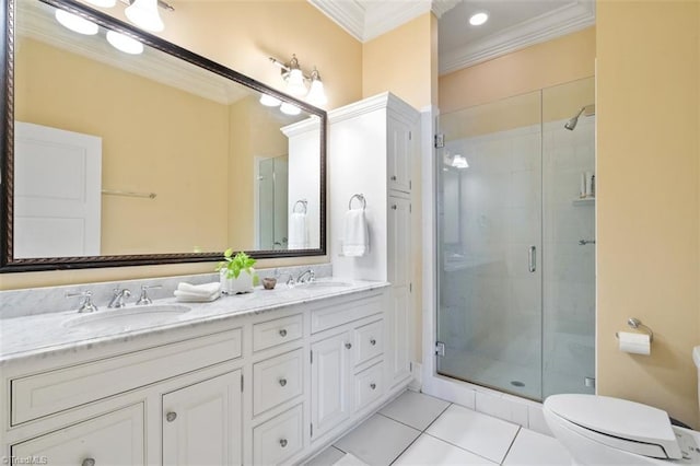 full bathroom with a sink, a shower stall, crown molding, and tile patterned floors