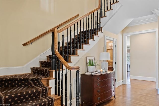 stairway with wood finished floors and baseboards