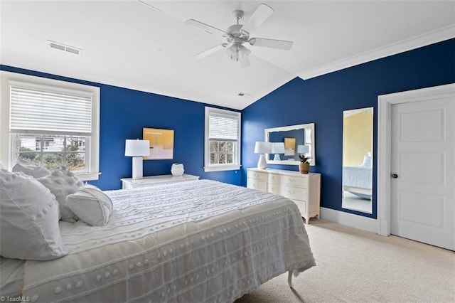 bedroom with visible vents, multiple windows, lofted ceiling, and carpet floors