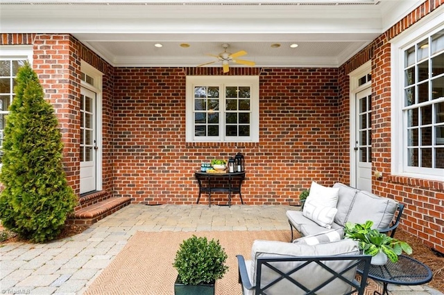 view of patio with an outdoor living space and ceiling fan