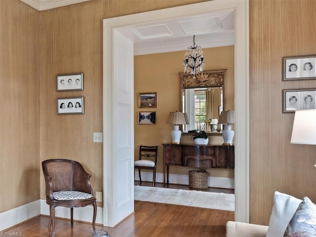 interior space with wood finished floors, baseboards, and ornamental molding