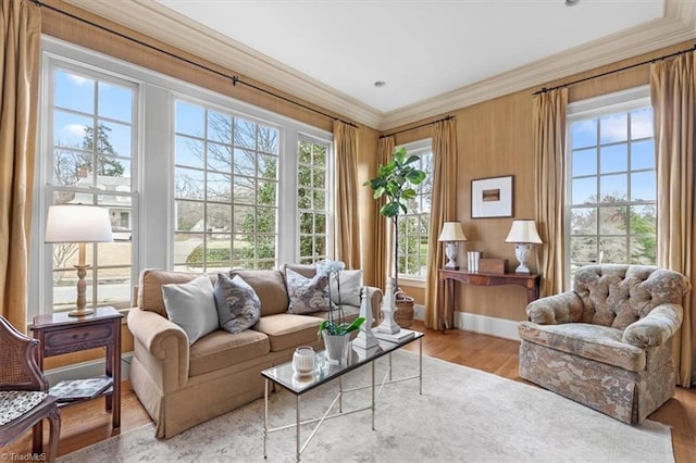 living area featuring wood finished floors and ornamental molding