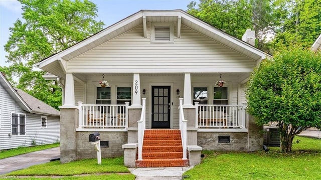 209 Burtner St, Greensboro, NC 27406 - bungalow-style house featuring a porch and a front yard