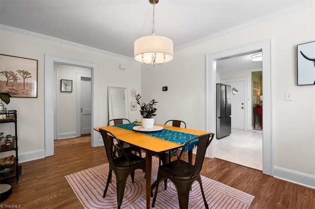 209 Burtner St, Greensboro, NC 27406 - dining area with wood finished floors, ornamental molding, and baseboards