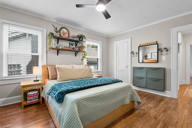209 Burtner St, Greensboro, NC 27406 - bedroom featuring wood finished floors, crown molding, a textured ceiling, baseboards, and ceiling fan