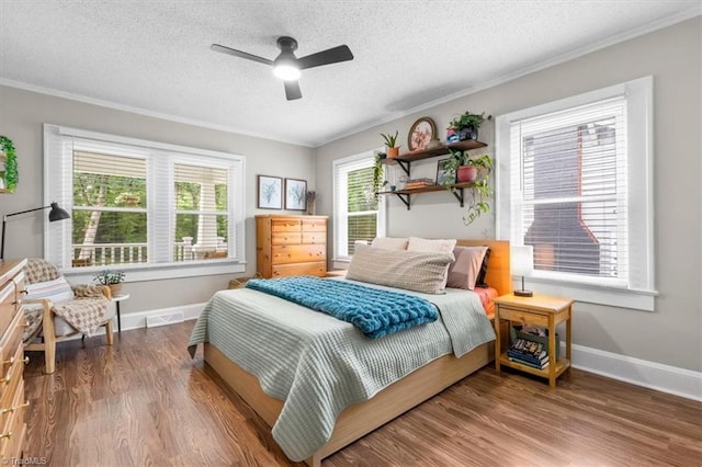 209 Burtner St, Greensboro, NC 27406 - bedroom featuring ornamental molding, baseboards, wood finished floors, a textured ceiling, and ceiling fan