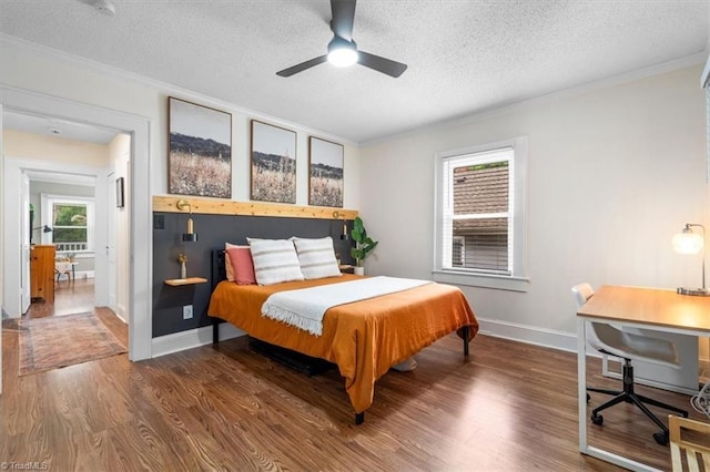 209 Burtner St, Greensboro, NC 27406 - bedroom featuring wood finished floors, crown molding, a textured ceiling, baseboards, and ceiling fan