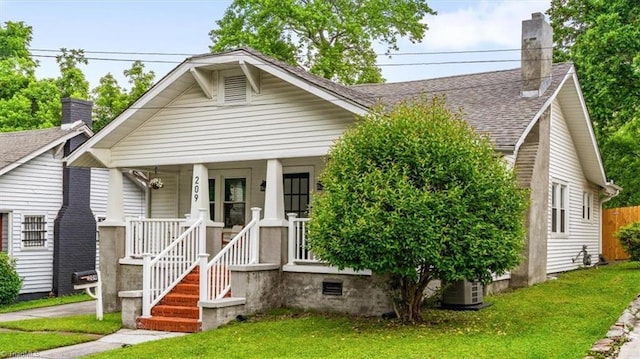 209 Burtner St, Greensboro, NC 27406 - view of front of home with roof with shingles, a front lawn, a porch, a chimney, and central AC unit