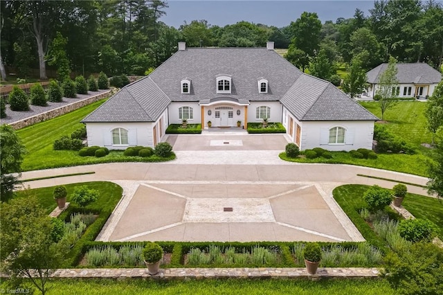 2632 Bartram Pl, Winston-Salem, NC 27106 - french provincial home featuring curved driveway, a chimney, and french doors