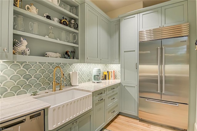 2632 Bartram Pl, Winston-Salem, NC 27106 - kitchen with appliances with stainless steel finishes, open shelves, backsplash, and light wood-style floors