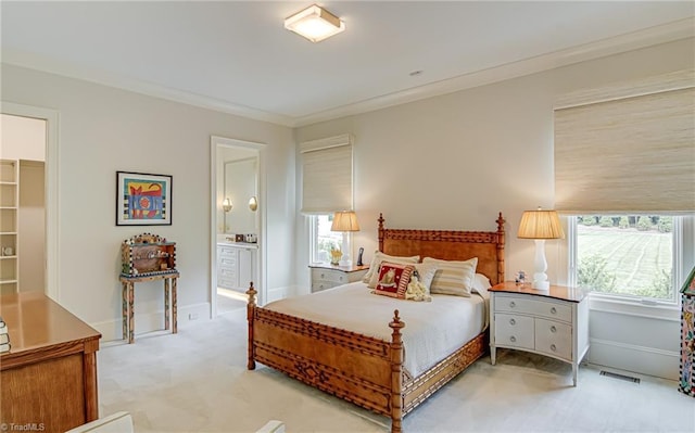 2632 Bartram Pl, Winston-Salem, NC 27106 - bedroom featuring light carpet, crown molding, connected bathroom, and a walk in closet