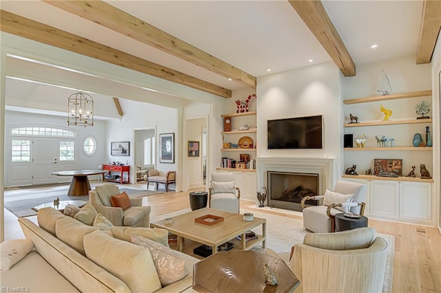 2632 Bartram Pl, Winston-Salem, NC 27106 - living room featuring beamed ceiling, light wood-style floors, a chandelier, and a fireplace with flush hearth
