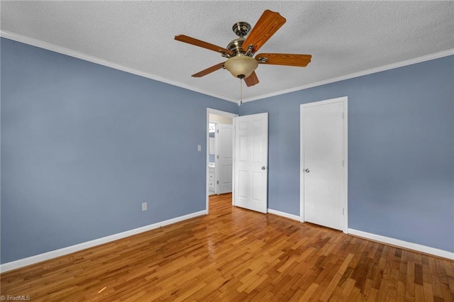 unfurnished bedroom with ceiling fan, crown molding, hardwood / wood-style floors, and a textured ceiling