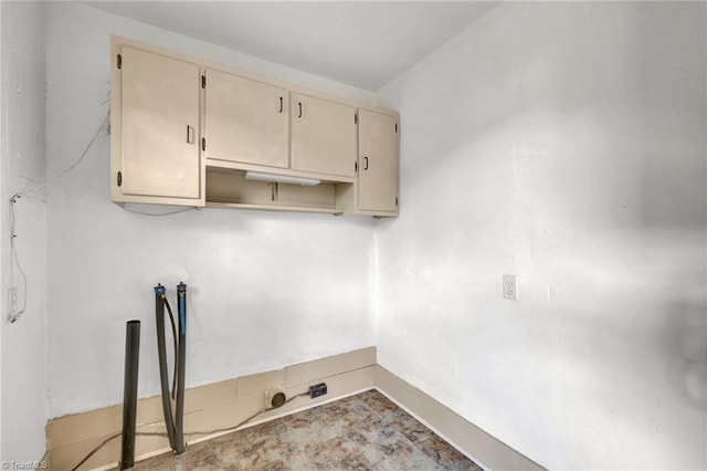 washroom featuring washer hookup and cabinets