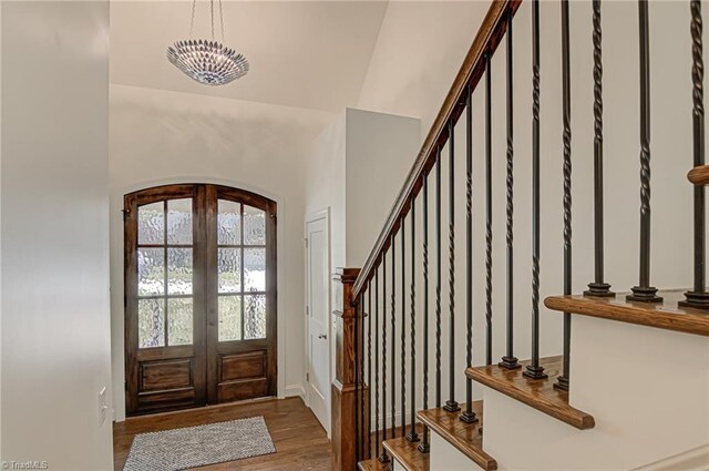 foyer entrance with french doors and hardwood / wood-style flooring