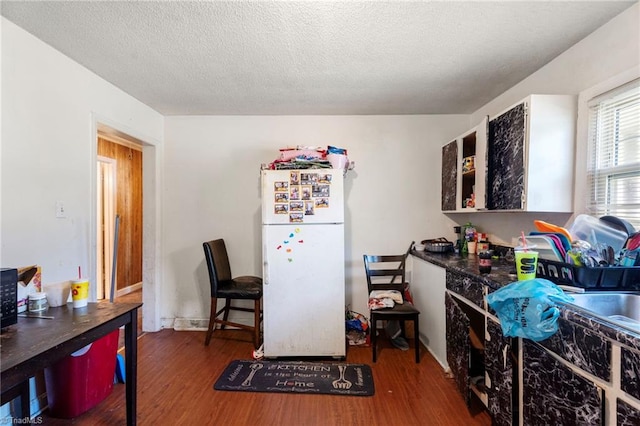 3410 Lambeth St, Winston-Salem, NC 27107 - kitchen with freestanding refrigerator, wood finished floors, and a textured ceiling