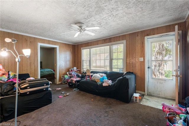 3410 Lambeth St, Winston-Salem, NC 27107 - carpeted living area featuring wooden walls, a textured ceiling, ceiling fan, and crown molding