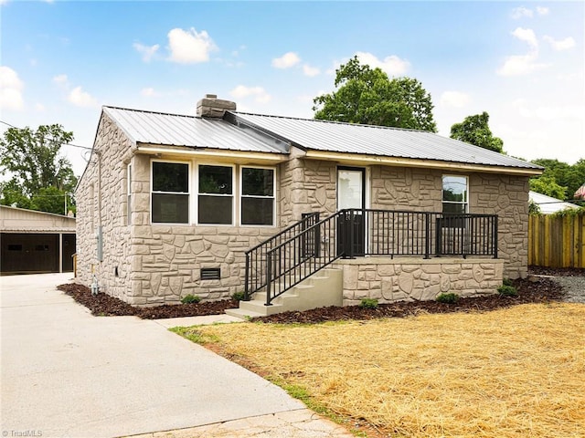 207 Snider Ave, Lexington, NC 27292 - bungalow-style house featuring stone siding, a detached garage, metal roof, a chimney, and an outbuilding