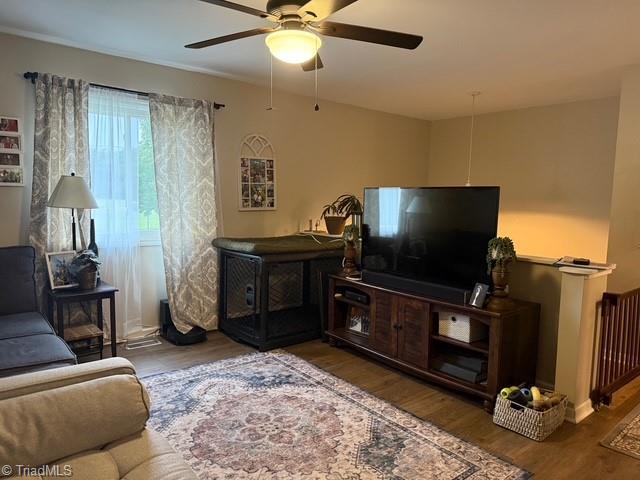 7098 E Fork Rd, High Point, NC 27265 - living room featuring wood finished floors, ceiling fan, and radiator