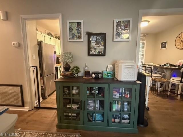 7098 E Fork Rd, High Point, NC 27265 - indoor dry bar with freestanding refrigerator and light wood-style floors