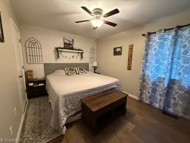 7098 E Fork Rd, High Point, NC 27265 - bedroom featuring wood finished floors, a ceiling fan, and baseboards